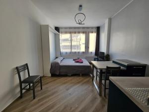 a small room with a bed and a table and chairs at Casa al mare Angela in Ventimiglia