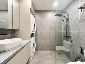 a bathroom with a sink and a shower at HOD Apartment Tan Dinh in Ho Chi Minh City
