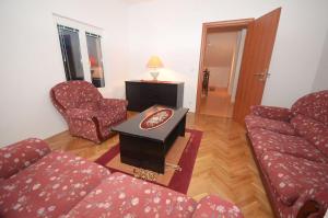 a living room with a couch and a table at Duplex apartman Petrović in Franciskovići +9 photos