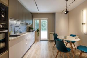 a kitchen with a table and chairs and a dining room at Downtown Breeze in Constanţa