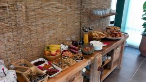 a table filled with lots of different types of food at Les Jardins de L'Ocean - Climatisé in Biscarrosse-Plage