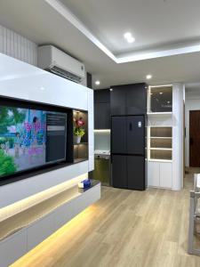 a kitchen with a flat screen tv on a wall at July homestay huế in Thôn Trường Giang