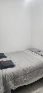 a bed with a gray comforter on top of it at Hospedagem Rio Lapa in Rio de Janeiro +11 photos