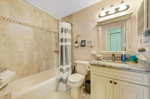 a bathroom with a tub and a toilet and a sink at Walk to North Beach in Clearwater Beach +44 photos