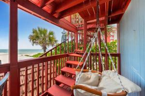 a porch with a hammock and a view of the beach at Walk to North Beach in Clearwater Beach