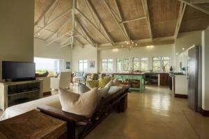 a large living room with a couch and a tv at Kangela 13 in Ponta Malongane
