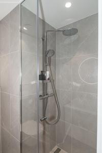 a shower with a glass door in a bathroom at Uus Volta in Tallinn +19 photos