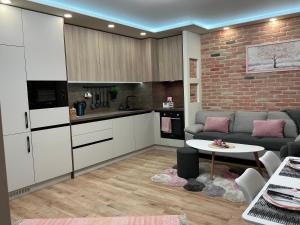 a kitchen and living room with a couch and a table at PlatinumHomes42 in Plovdiv