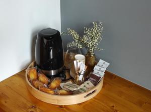 a basket with a coffee maker and a bunch of bread at Auberge Le LEO de FOIX in Foix