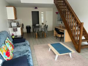 a living room with a couch and a table at Le Prieure Valette in Hérouville-Saint-Clair +19 photos