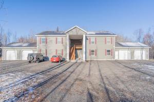 a large house with a car parked in front of it at Lower Northern Tanada Suite 2.0 (B) in North Pole