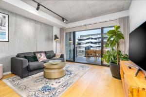 a living room with a couch and a table at Exclusive Braddon 2BR APT near Civic - Hosted by Canstay in Canberra