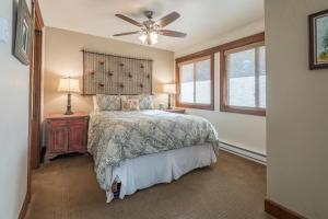 a bedroom with a bed and a ceiling fan at Andora Villa Condo 102 in Ketchum