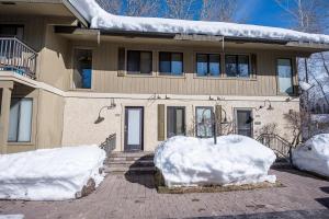 a house with snow on the front of it at Andora Villa Condo 102 in Ketchum