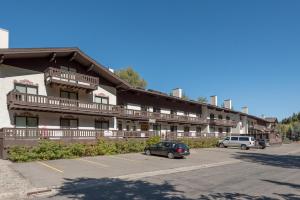 a large building with cars parked in a parking lot at Edelweiss Condo 223B in Ketchum