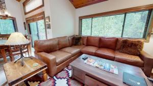 a living room with a brown leather couch at Bridgepoint Condo 24 in Ketchum