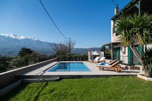 a backyard with a swimming pool and a house at Villa Aloni in Chania in Káïna