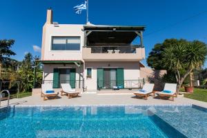a villa with a swimming pool and a house at Villa Aloni in Chania in Káïna