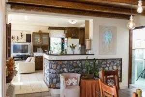 a kitchen and living room with a stone wall at Villa Aloni in Chania in Káïna