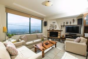 a living room with a couch and a tv at Villa Aloni in Chania in Káïna