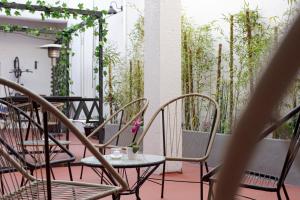 a table and chairs on a patio with plants at PH Palermo Hostel in Buenos Aires