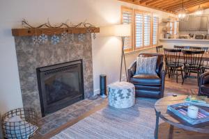 Una sala de estar con chimenea y una mesa. en Ranch Condo 3538, en Elkhorn Village