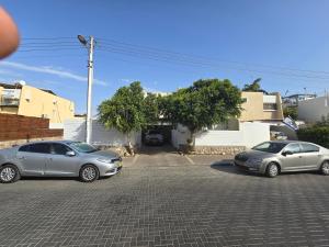 a group of three cars parked in a parking lot at Neviot in Eilat