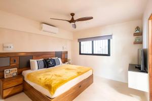 a bedroom with a large bed and a television at Departamento amplio con balcon y mini alberca privada in Tulum +16 photos