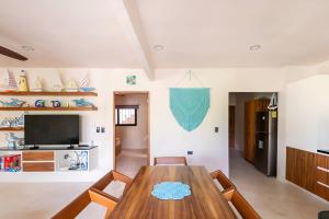 a dining room with a wooden table and chairs at Departamento amplio con balcon y mini alberca privada in Tulum