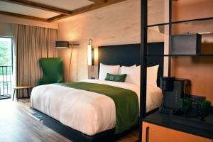 a hotel room with a bed and a television at The Swiftwater in Swiftwater