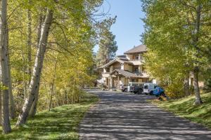 a tree lined road in front of a house at Wildflower Condo 617 in Sun Valley