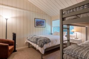 a bedroom with a bunk bed and a chair at Villager Condo 1207 in Sun Valley +31 photos