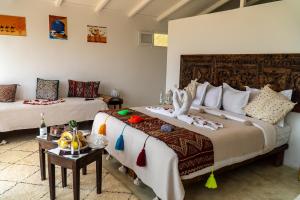a bedroom with two beds with decorations on them at PK25 Dakhla in Dakhla