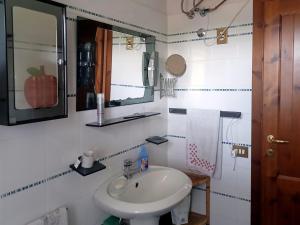 a white bathroom with a sink and a mirror at Chalet Relax&Salute in Pianosinatico +55 photos