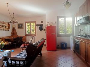 a kitchen with a red refrigerator and a table at Chalet Relax&Salute in Pianosinatico