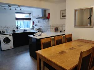 a kitchen with a table and a sink and a washing machine at Charming home in Beverley in Beverley