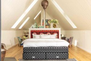 a bedroom with a large bed in a attic at Sail Loft in Acharacle