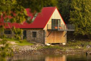 a house with a red roof and a balcony at Sail Loft in Acharacle