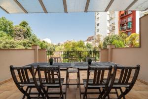 a table and chairs on the balcony of a building at Stay U-nique Apartments Nació in Barcelona