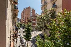 an empty street in a city with tall buildings at Stay U-nique Apartments Nació in Barcelona