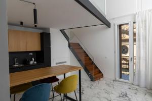 a kitchen with a table and chairs and a staircase at La Dimora dei Paladini in Bagheria