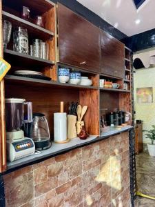 a kitchen with wooden shelves with utensils at Elegant and Comfortable Apartment in the Heart of Rabat in Rabat