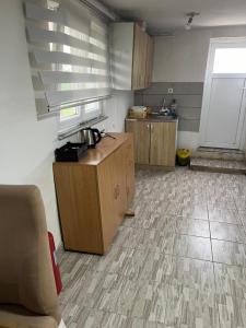 a room with a kitchen with wooden cabinets at Apartment rebl Breza in Breza