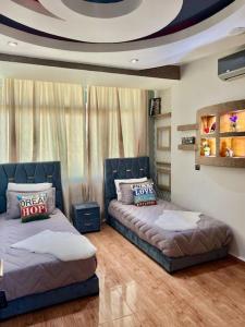 a living room with two beds and a couch at Elegant and Comfortable Apartment in the Heart of Rabat in Rabat