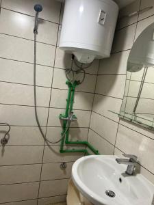 a bathroom with a toilet and a sink and a water hose at Apartment rebl Breza in Breza