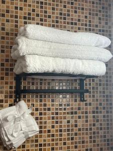 a group of towels on a shelf in a bathroom at Elegant and Comfortable Apartment in the Heart of Rabat in Rabat