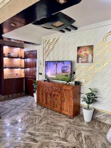 a living room with a flat screen tv on a wall at Elegant and Comfortable Apartment in the Heart of Rabat in Rabat