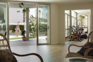 a living room with glass doors and a table and chairs at LAN Suites Antilla Playa in La Antilla