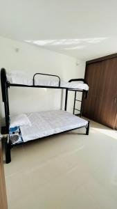 two bunk beds in a room with a door at Acogedor apartamento in Melgar