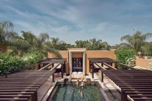 an aerial view of a pool with people in the water at Mandarin Oriental, Marrakech in Marrakesh +72 photos